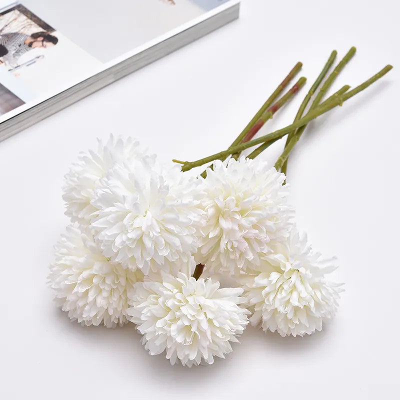 Celine Faux Dandelion Flower with lifelike petals on a white table.