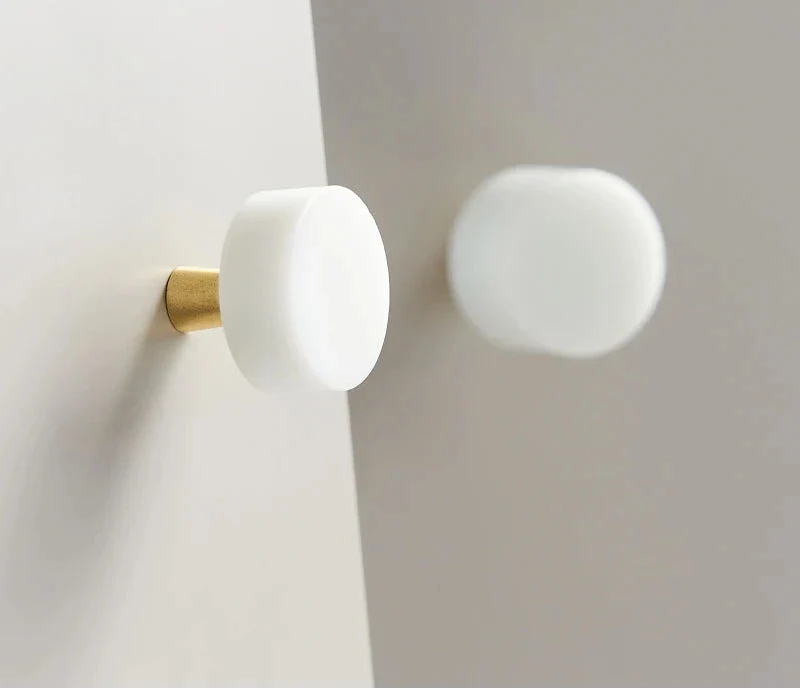 Elegant Anessa Handles with brass base and white marble finish.