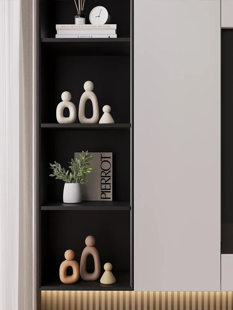 Minimalism Family Statue with neutral tones on shelf displaying modern decor.