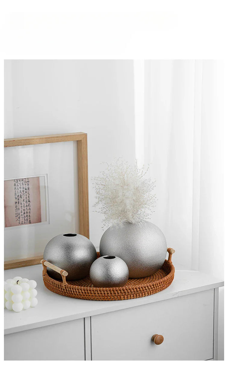 Nuala Ceramic Balls in silver used as vases on a tray, elegant home decor.