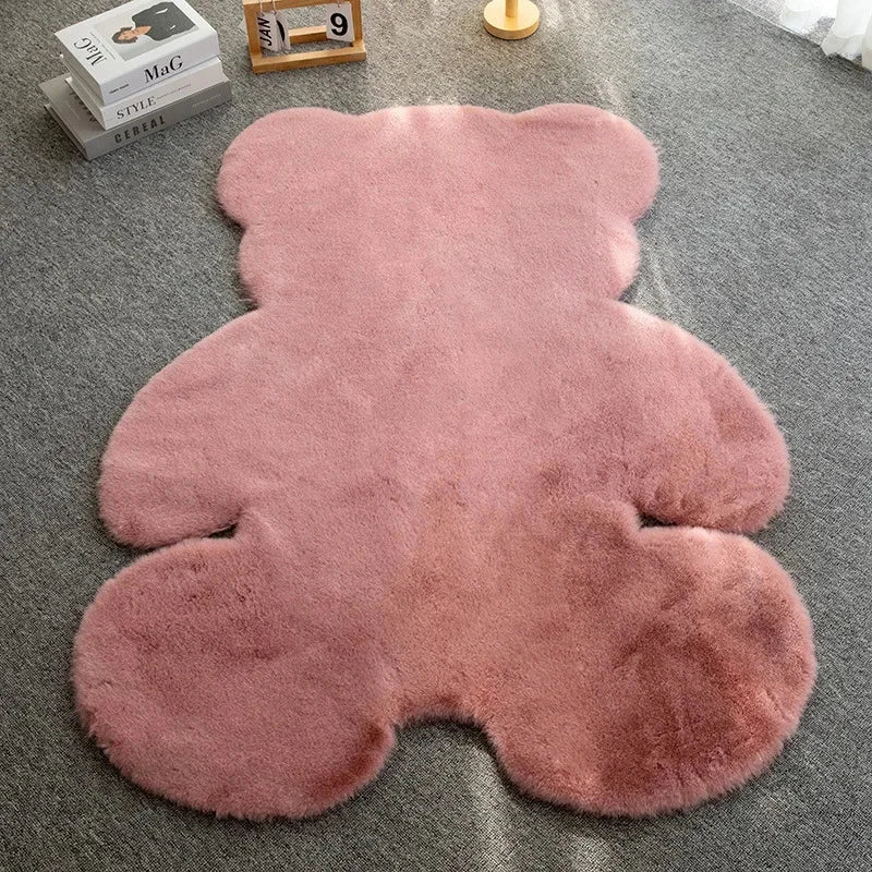 Matt the Bear Rug made of pink faux fur on a gray carpeted floor.