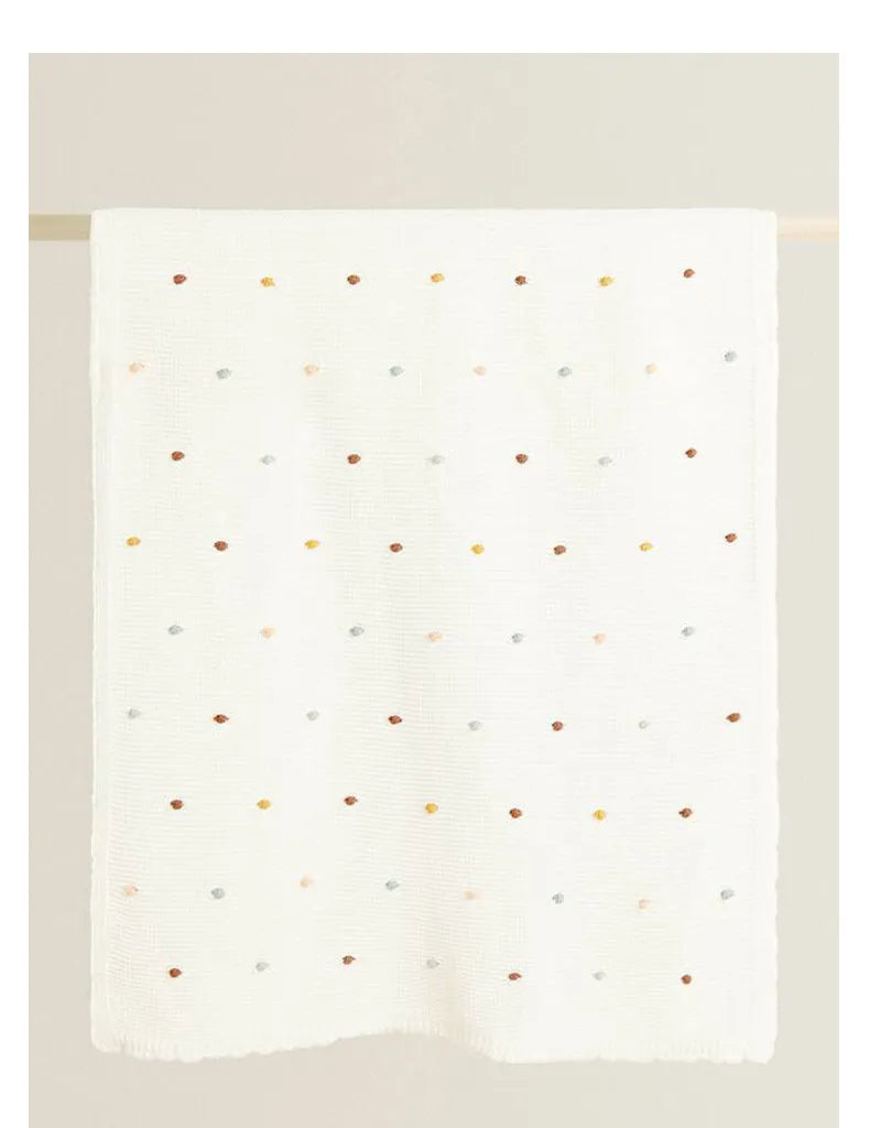 Zion Baby Blanket in soft, luxurious fabric with colorful dots design.