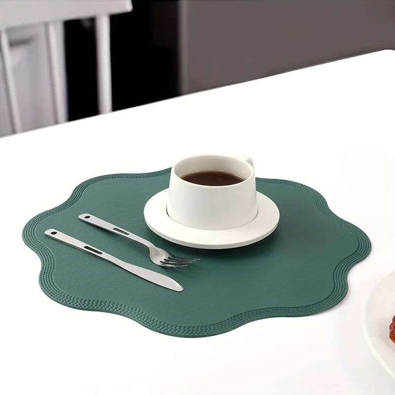 Noah's Placemats in elegant green, enhancing a dining table with a cup of coffee and cutlery.