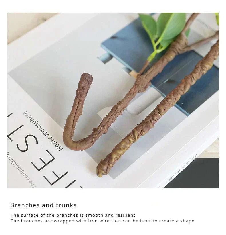 Faux withered branches with realistic texture and tender buds, displayed on a book.