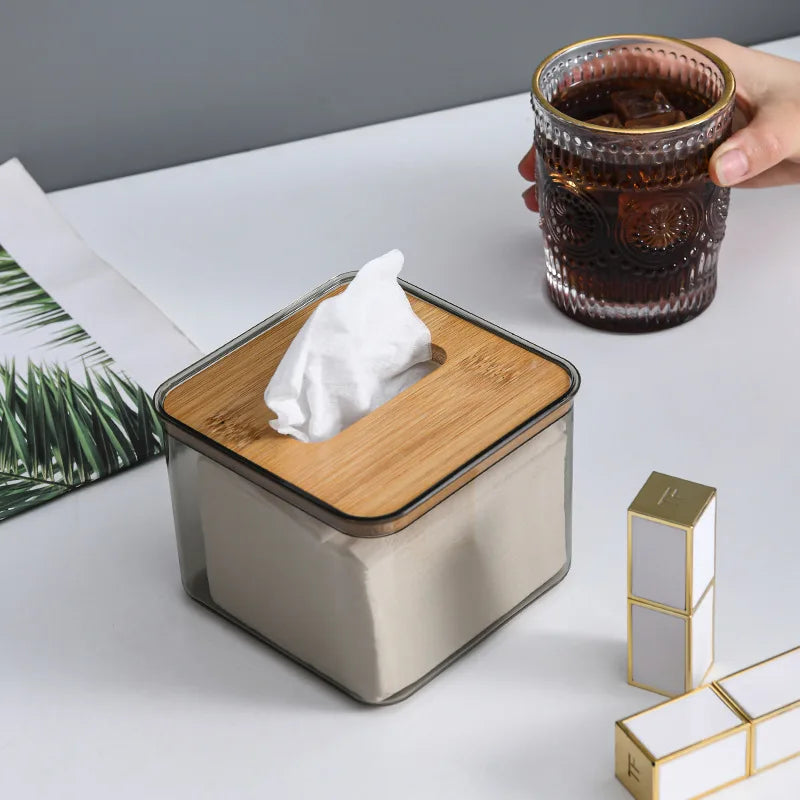 Sïmh Wooden Tissue Box on a table with a drink and decorative items.