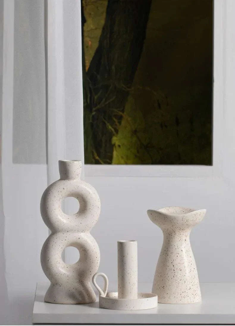 SUKi candle holders showcasing minimalist ceramic design on a table.