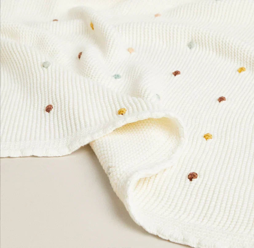 Soft Zion Baby Blanket with colorful polka dots, offering luxury and warmth for infants.