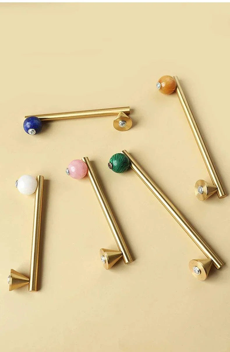 Natural crystal and brass furniture handles with colorful knobs for elegant decor.