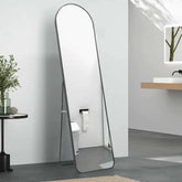 Arched mirror with metal frame, black color, wall mounted or freestanding, suitable for various rooms.