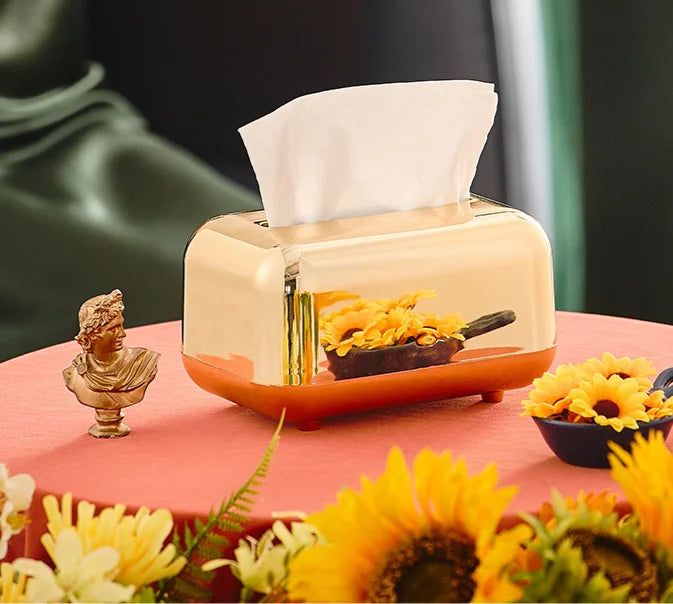Luxie tissue box with luxurious gold finish on decorative table.