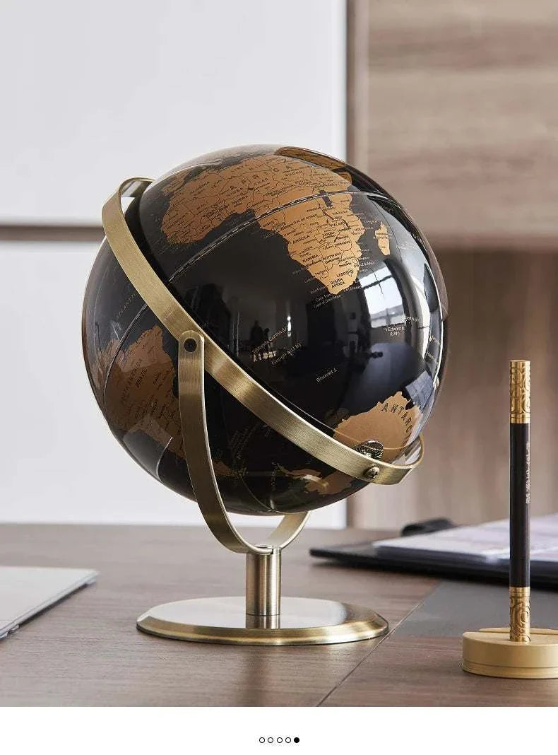 Aya Globes in black and gold on a desk, elegant decor piece for home or office.