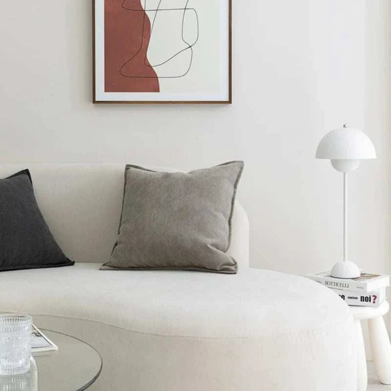 Neutral-toned Noori Cushion covers displayed on a modern sofa.