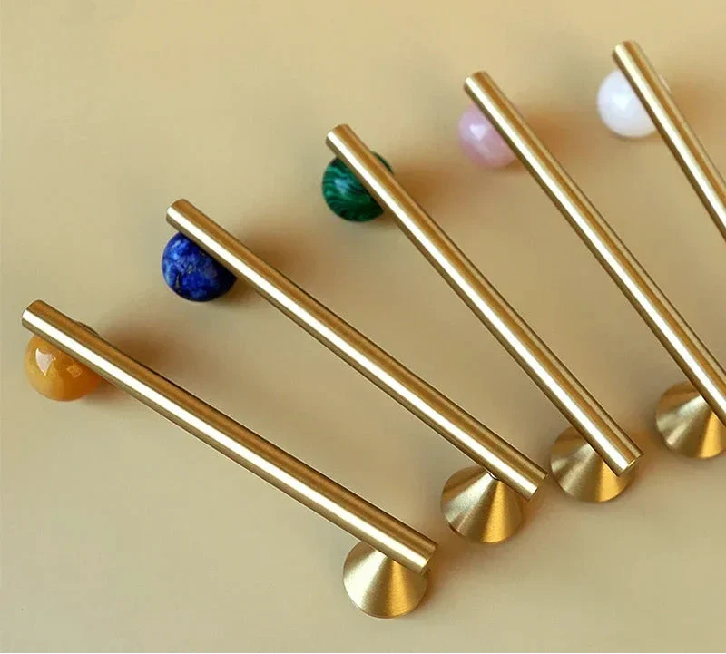 Natural crystal and brass furniture handles in various colors, elegant cabinet knobs for home decor.