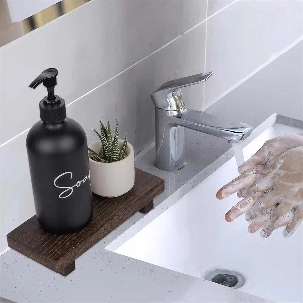 Small Wood Riser on bathroom counter with soap dispenser and plant.