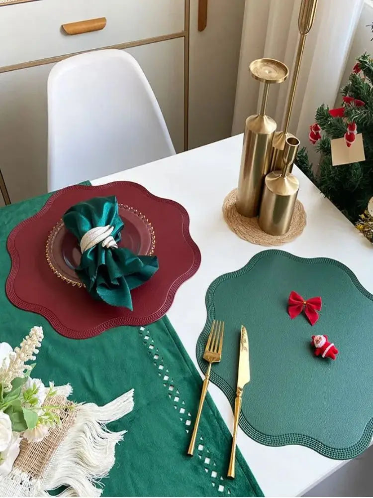 Noah's Placemats in elegant red and green designs, enhancing a dining table setting with gold cutlery.