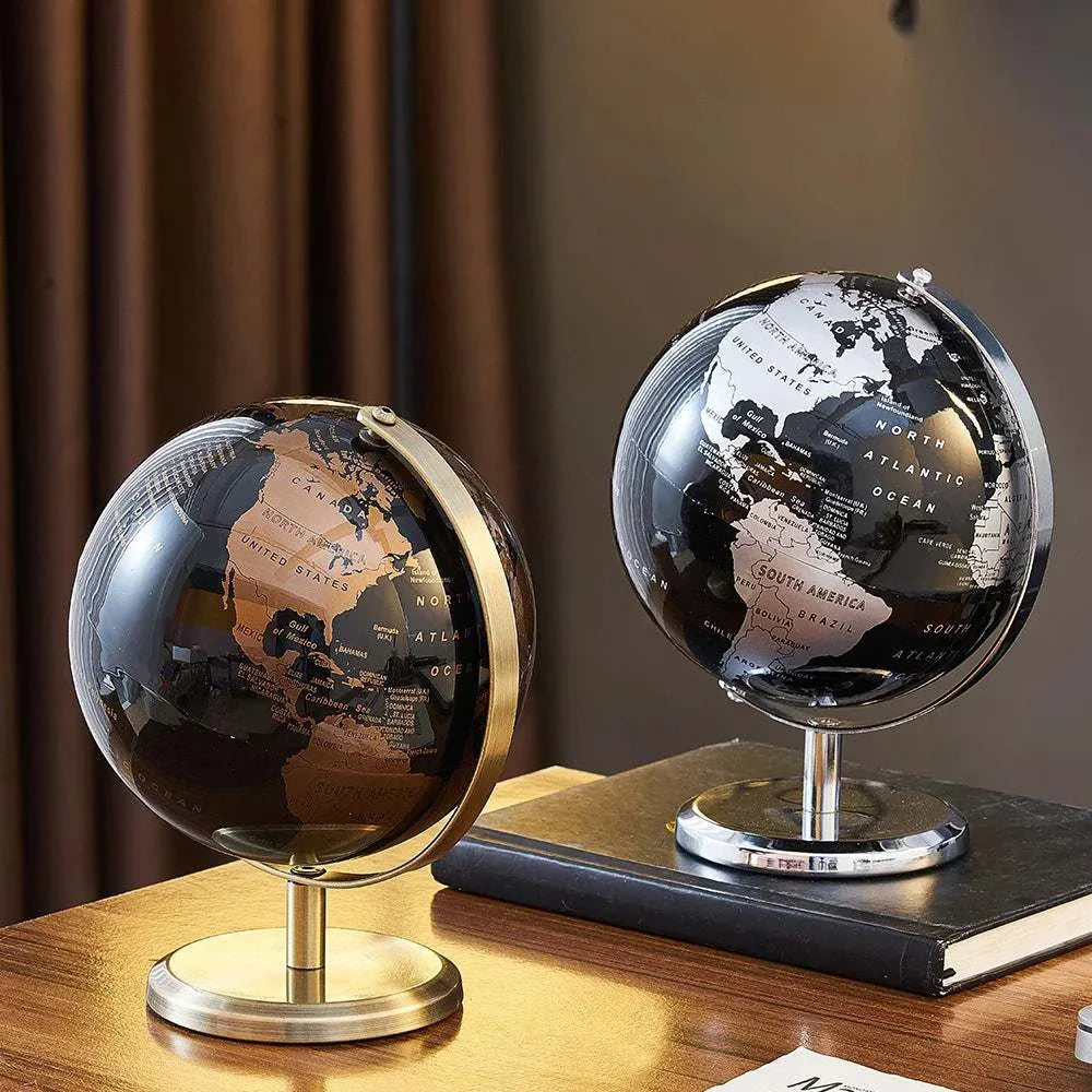 Aya Globes in black and bronze on a wooden table, enhancing decor with sophistication.