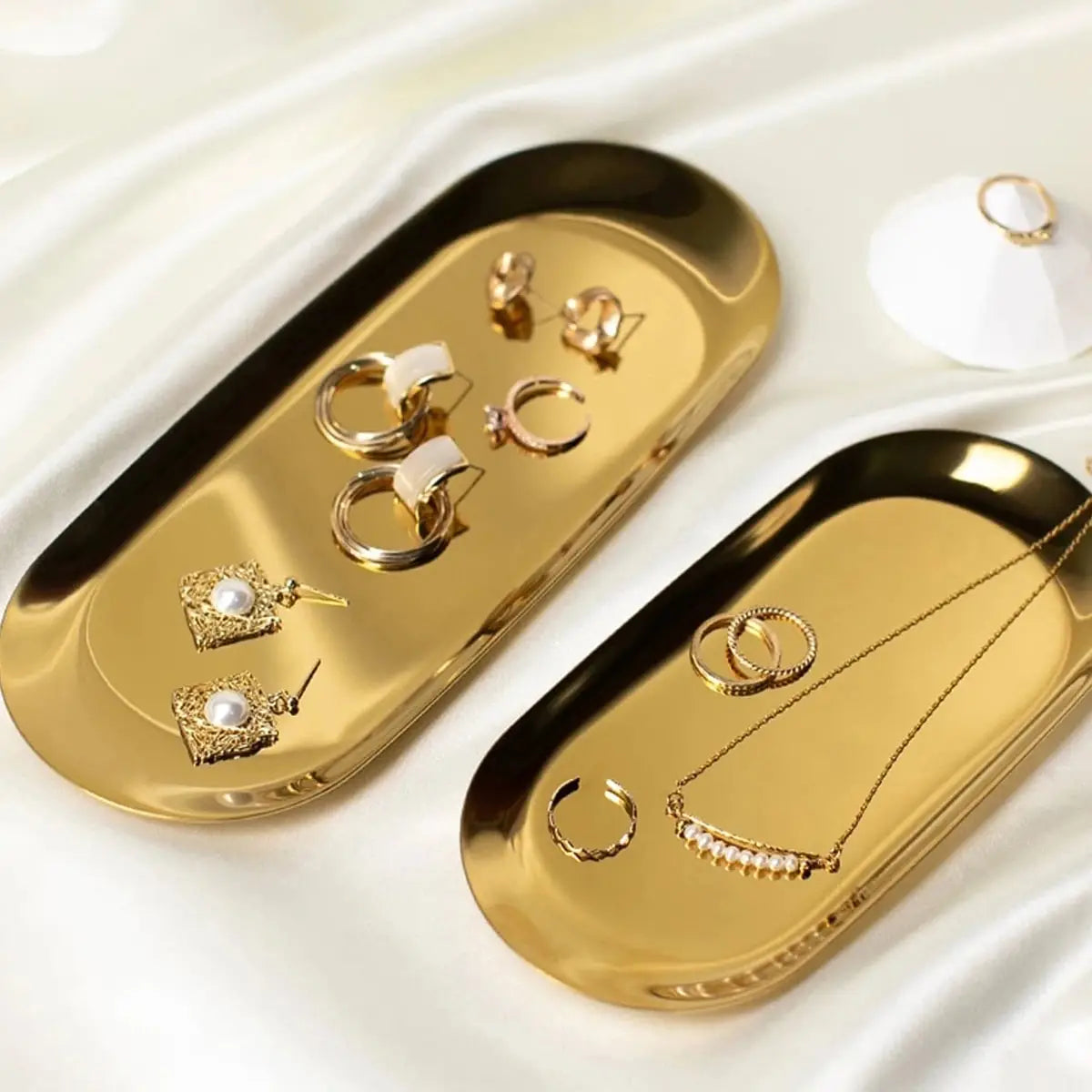 Stainless Steel Oval Tray displaying jewelry in gold finish.