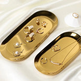 Stainless Steel Oval Tray displaying jewelry in gold finish.