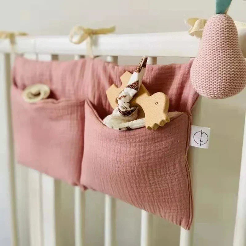 Arian Baby Crib Storage Bag hanging on crib with toys stored, made of soft, durable cotton.