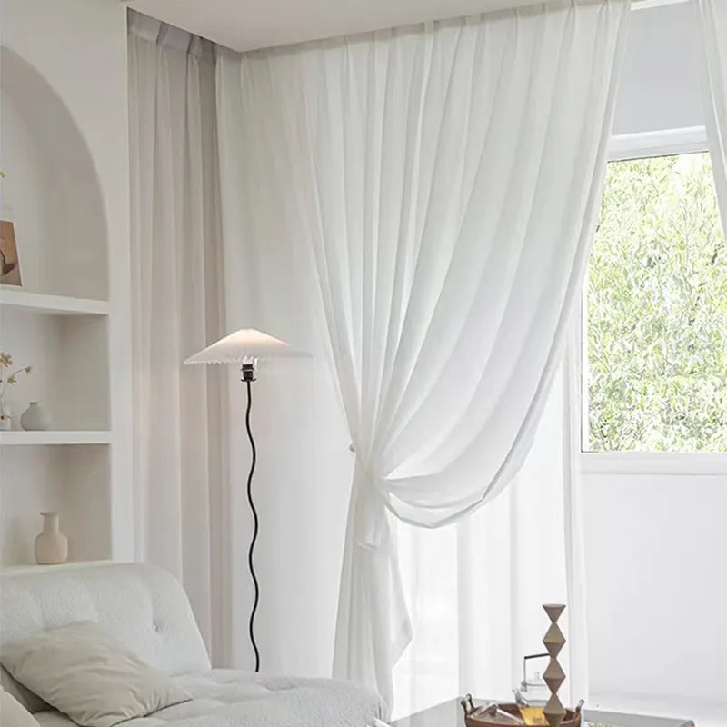 Asazal White Tulle Curtains hanging in a bright room, adding elegance and privacy.