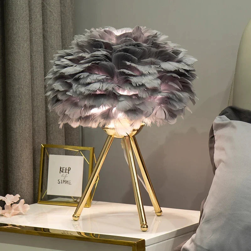 Feather Table Lamp with delicate feathers on a modern base illuminating a cozy room setting.