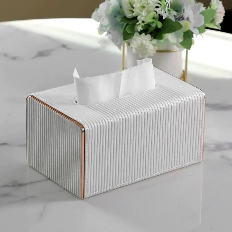 Ribbed Tissue Box on a table with floral decoration in the background.