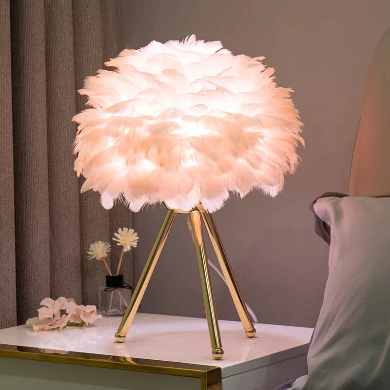 Feather Table Lamp with soft glowing feathers on a golden tripod stand, enhancing room decor.