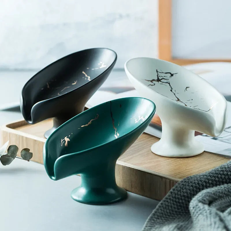 Ceramic soap dish in black, teal, and white, showcasing elegant marble patterns, perfect for kitchen cleaning.