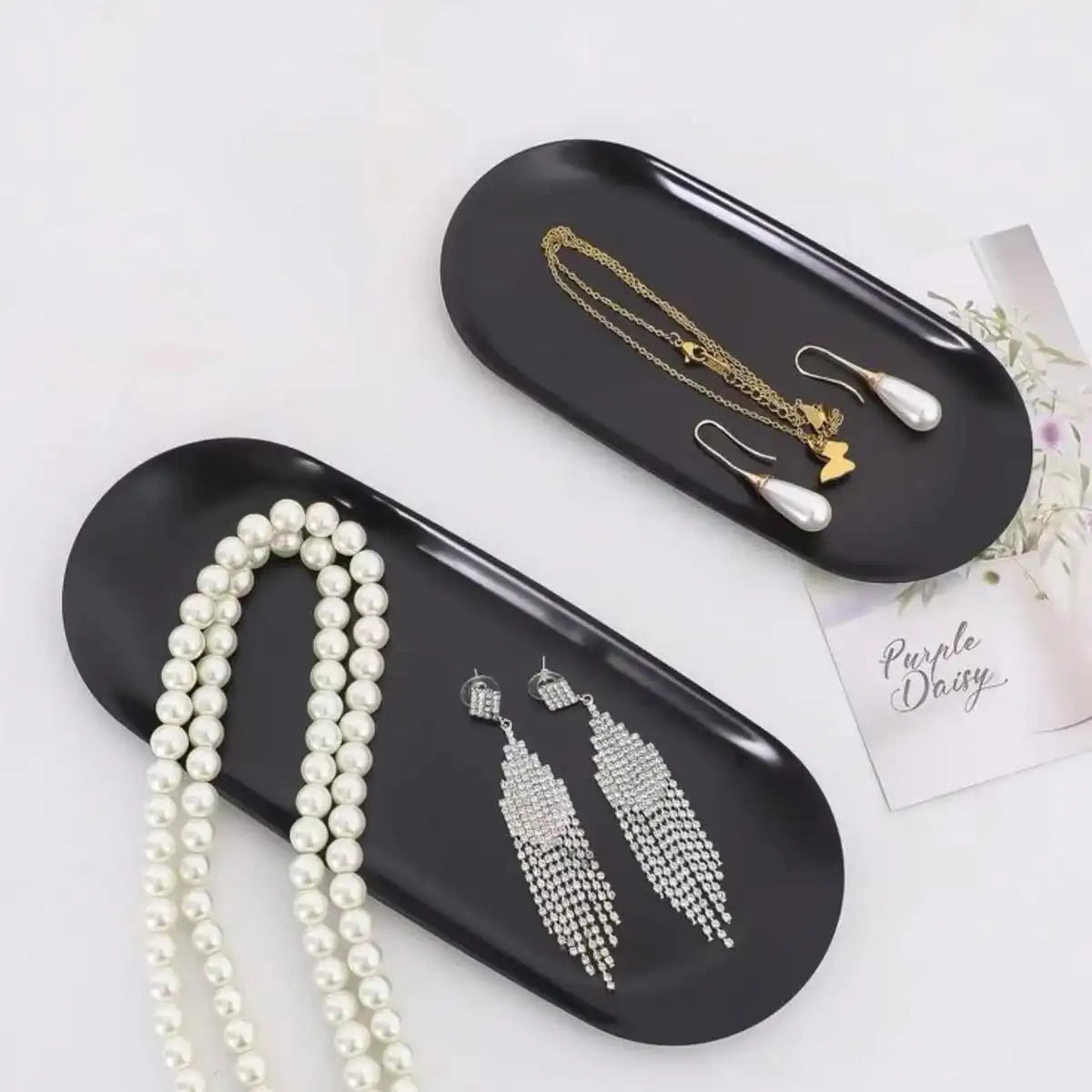 Stainless Steel Oval Tray in black displaying jewelry.