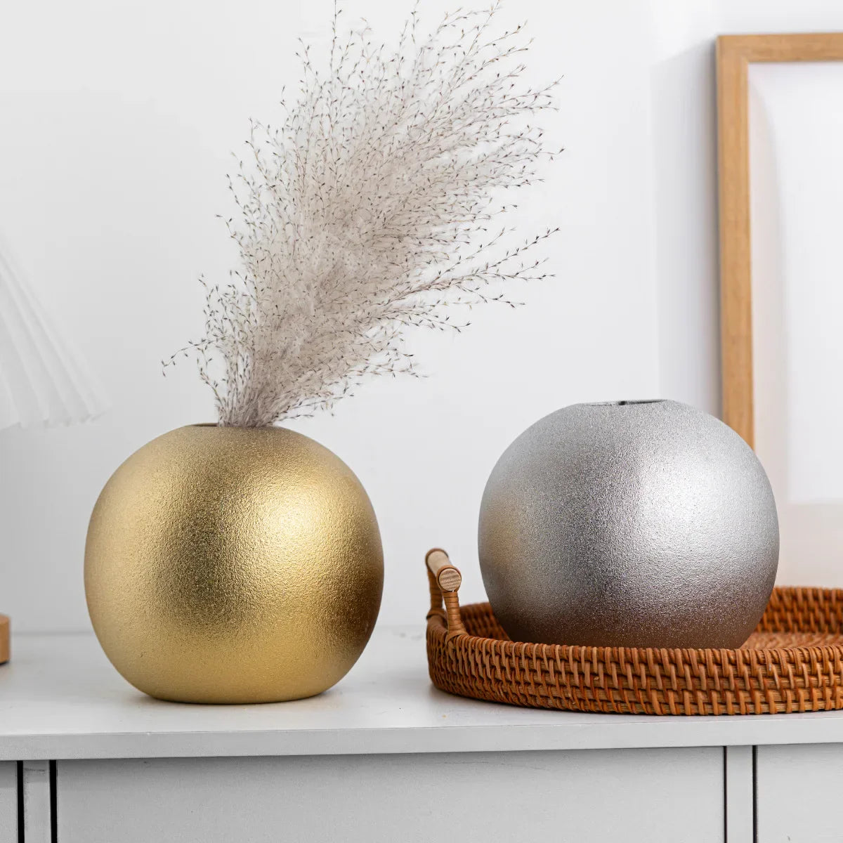 Nuala Ceramic Balls in silver and gold as decorative vase ornaments.