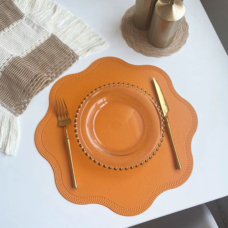 Noah's Placemats in orange, enhancing a dining table with elegance and style.