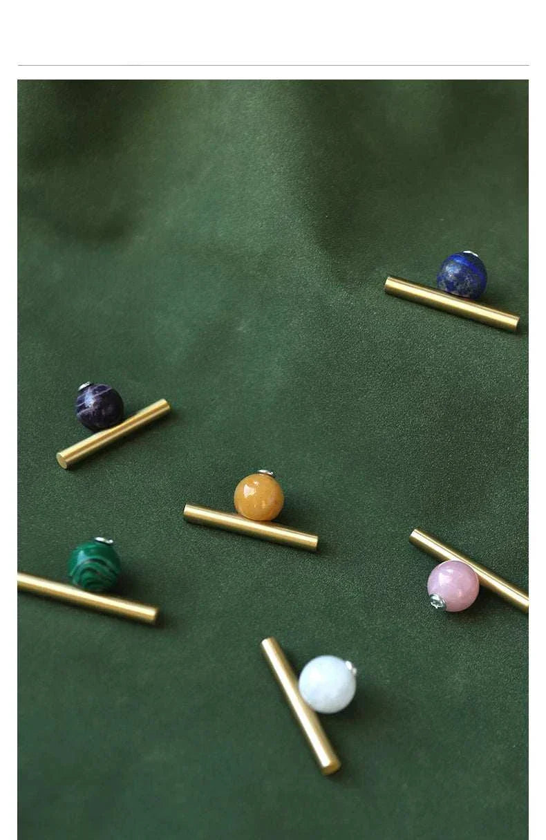 Natural crystal and brass furniture handles for elegant decor.