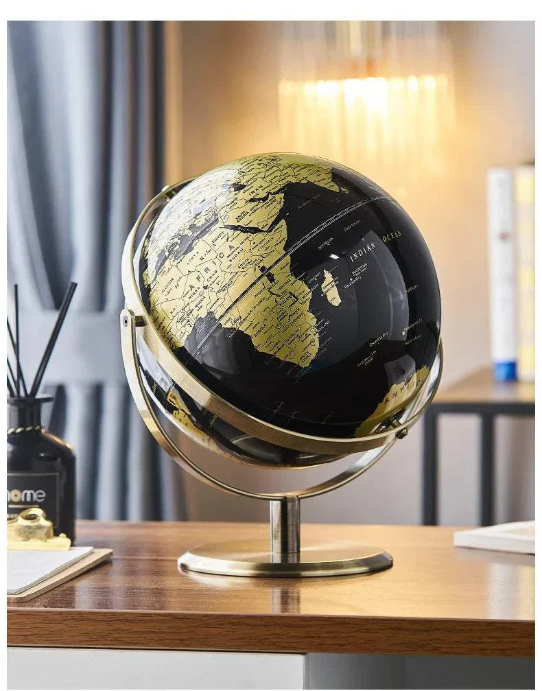 Aya Globes black and gold globe on desk enhances home or office decor.
