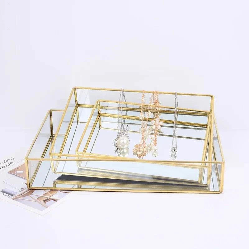 Luxurious Orter trays and box with brass and glass in gold finish for elegant organization.