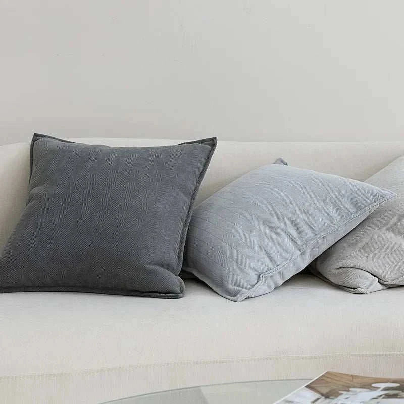 Noori Cushion Covers in various shades on a sofa.