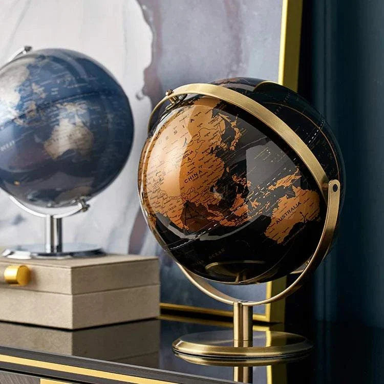 Elegant Aya Globes in black and bronze on a table, perfect for home or office decor.