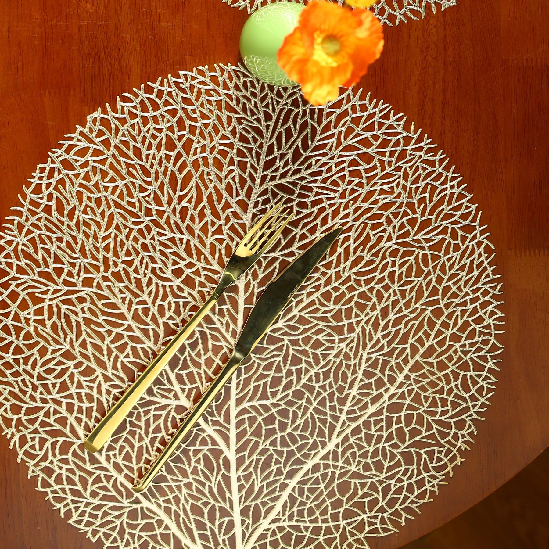 Ollie Placemats leaf design golden PVC table mats, set of four.