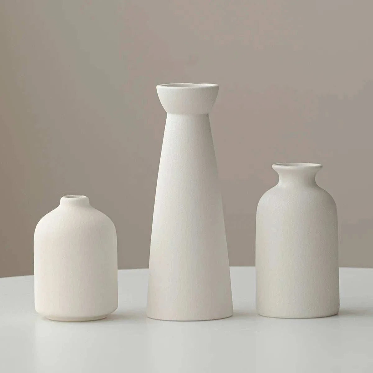 Minimalist cream ceramic Wulf Vases with sleek design for sophisticated home decor.