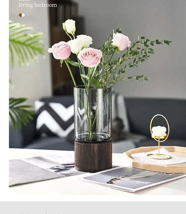 Sphinx Vase made of glass and wood with pink and white flowers.