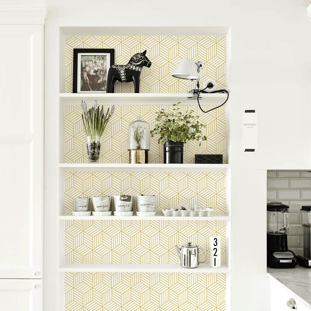 Geometric hexagon wallpaper on shelves in modern kitchen.
