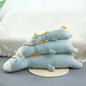 Giant unicorn pillow in cozy living room setting.