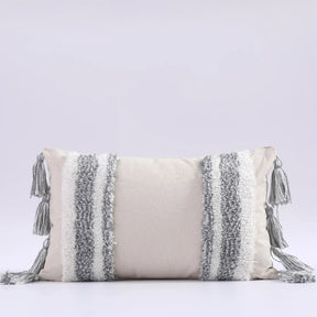 Moroccon style pillow case with intricate patterns and tassels.