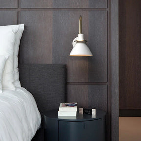 Dexter wall lamp with adjustable arm in a modern bedroom setting.
