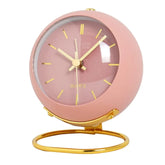 Electronic desk clock with minimalist design in pink and gold accents.