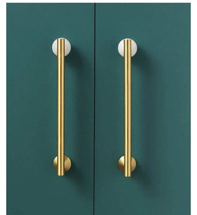 Natural Crystal + Brass Furniture Handles on green cupboards.