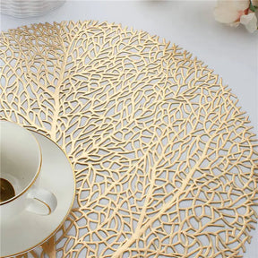 Ollie Placemats leaf design in golden PVC, modern table decor.