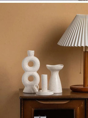 SUKi candle holders on a wooden table, enhancing room elegance.