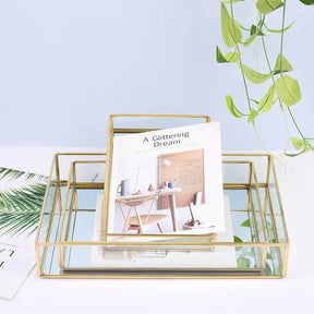 Luxurious Orter trays and box in gold finish, made of brass and glass, for elegant organization.