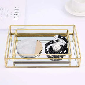 Luxurious Orter trays in brass and glass with a gold finish, ideal for elegant organization.