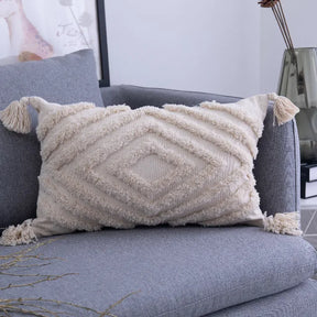 Moroccon style pillow case with intricate patterns on couch.